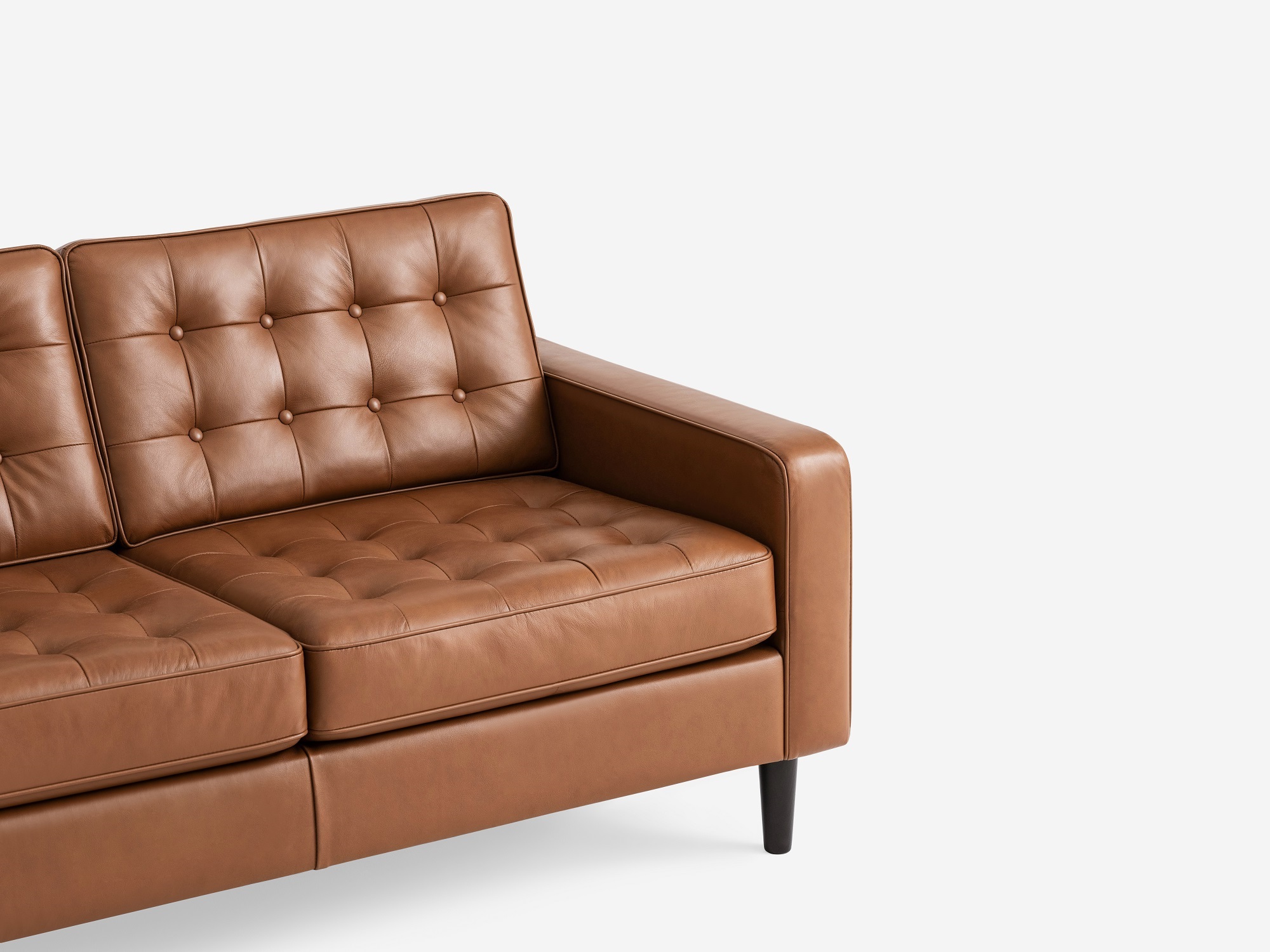 Corner view of the  Reverie modern sectional sleeper sofa in brown leather with left hand facing chaise