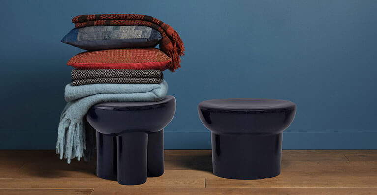 Small blue end tables are shown in against a blue wall. Link to eq3 bingo stools