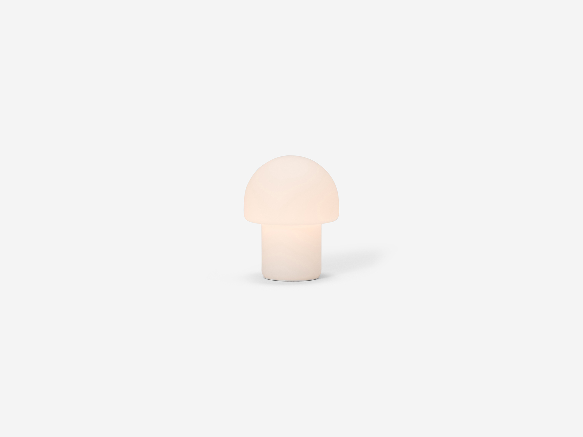 Small mushroom shaped table lamp with light on
