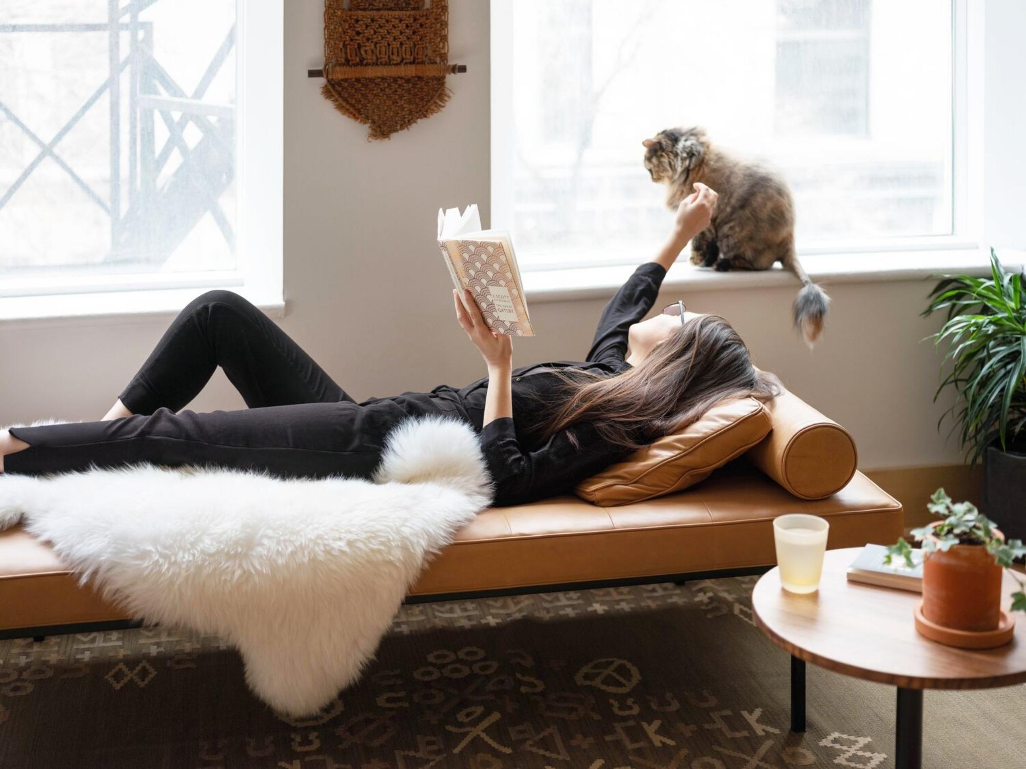 Woman on leather daybed with matching bolster cushion