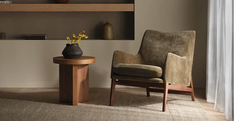 a fabric chair with wood trimming is displayed in front of a living room window. Link to new lounge chairs