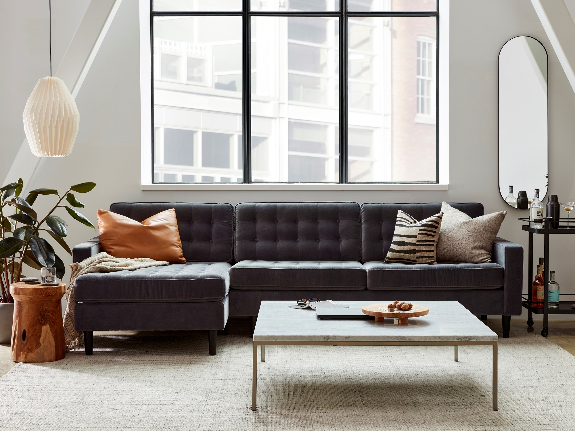 Grey sectional sofa and marble coffee table in a modern living room