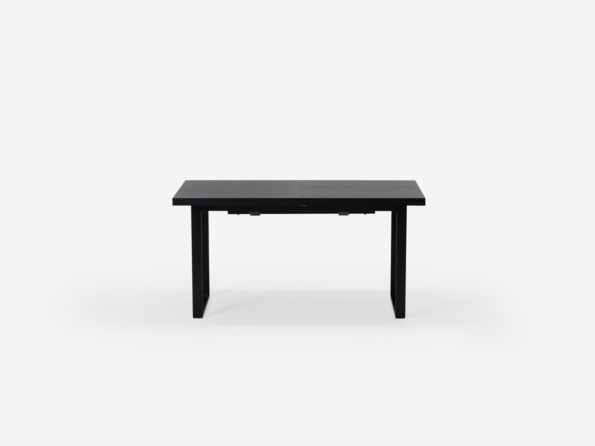 Side view of expandable dining table with black legs and black top