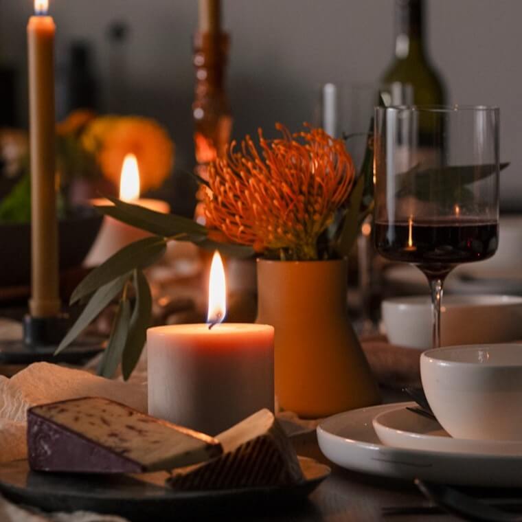 Assortment of dinnerware and accessories are shown on a black table.