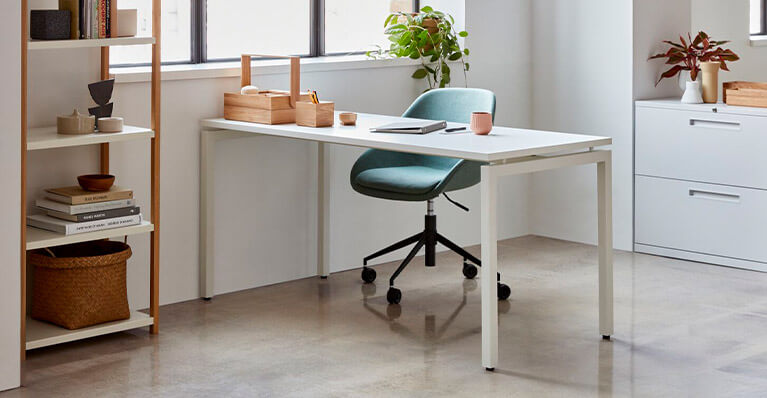 white office desk is displayed in a home office setting. Link to eq3 novah desk