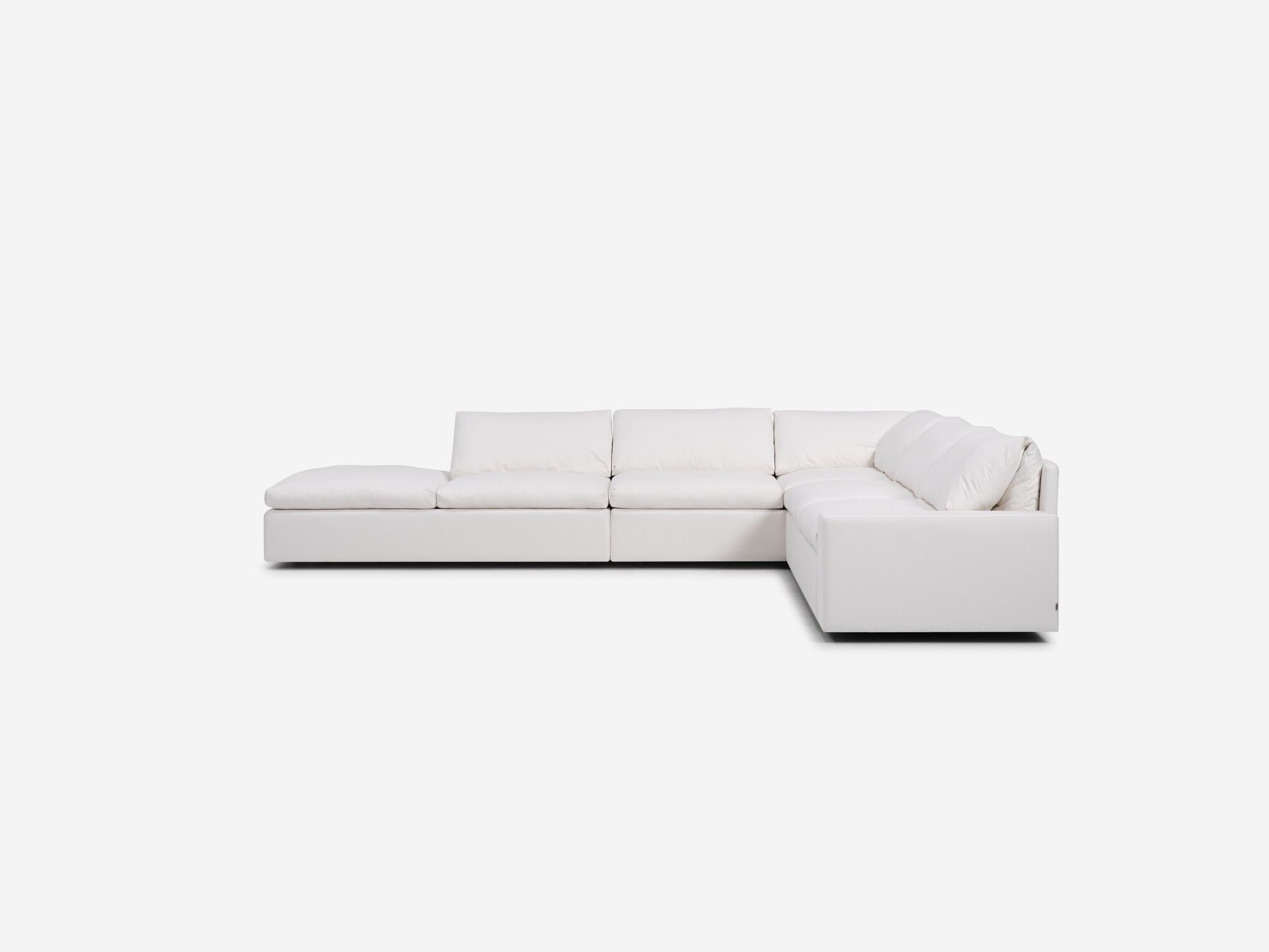 White sectional sofa with left hand chaise and wide arms side view
