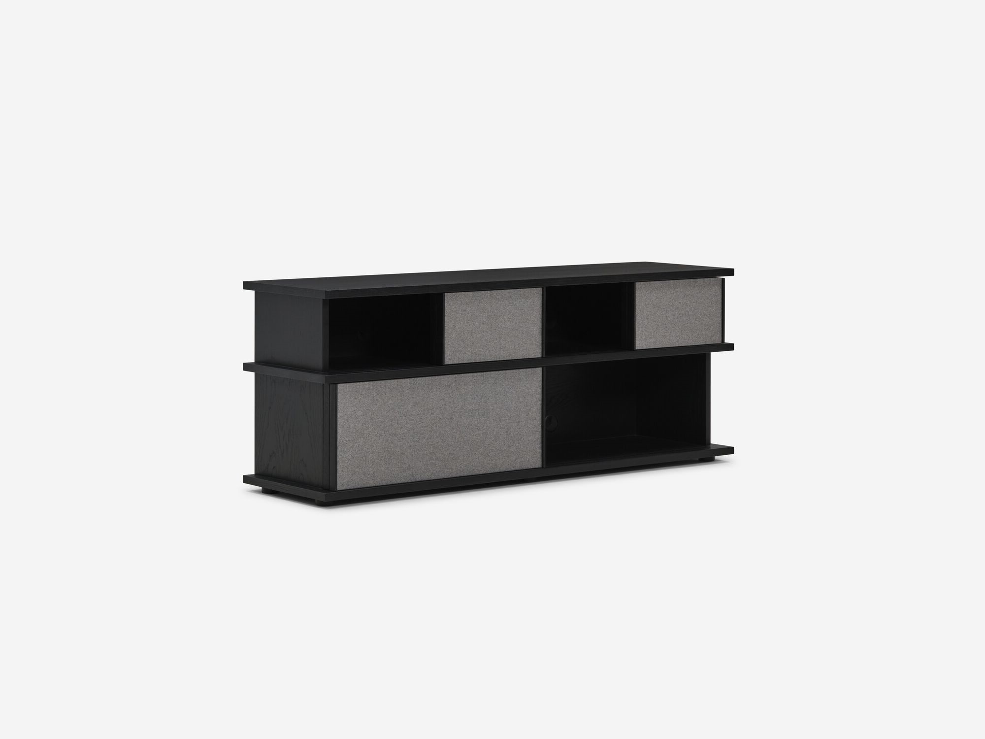 Front angle view of tall black oak media unit with fabric panels with open storage