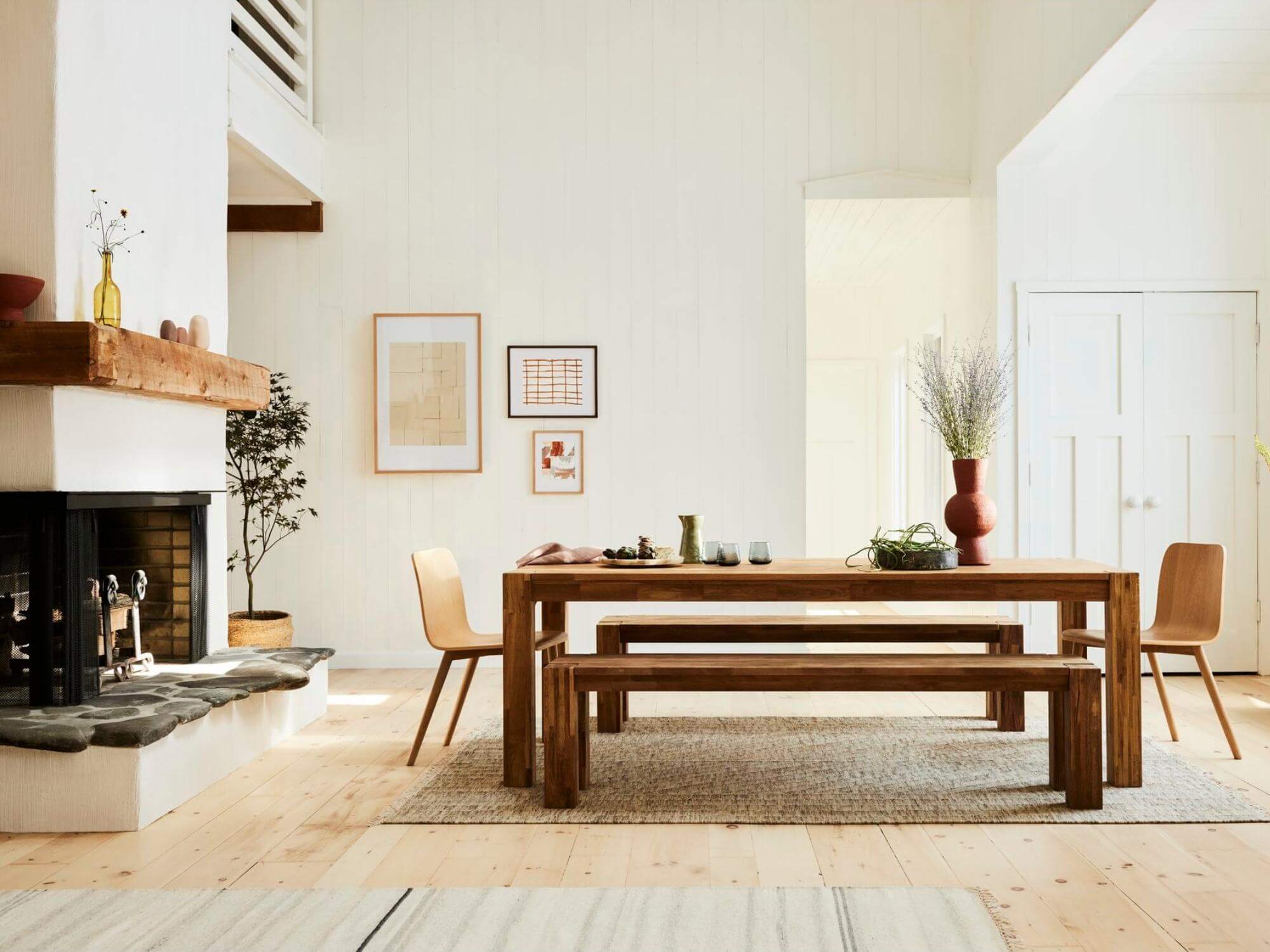 Black and oak picture frames leaning against wall of large modern living room