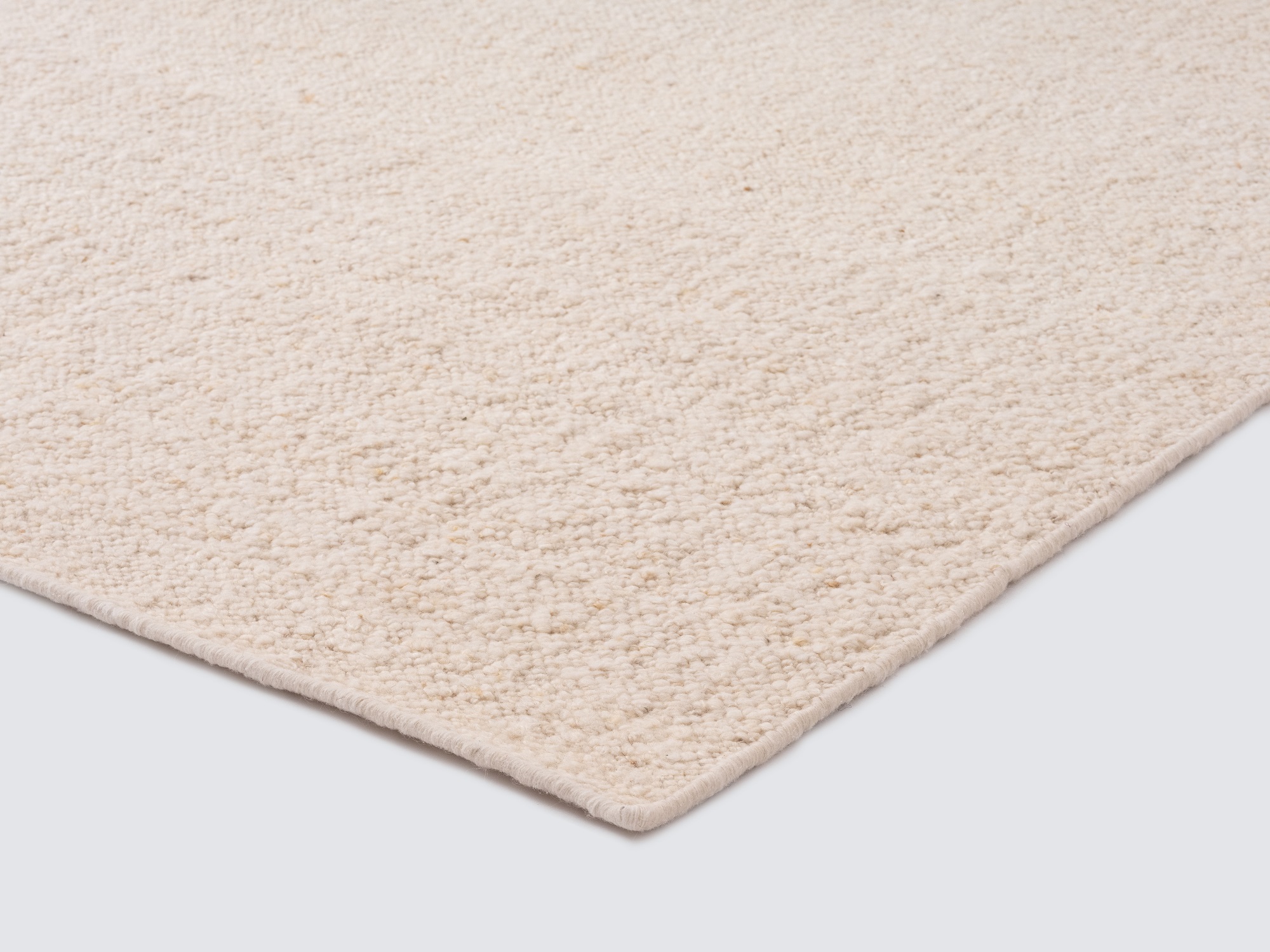 Detail corner view of lush ivory rug