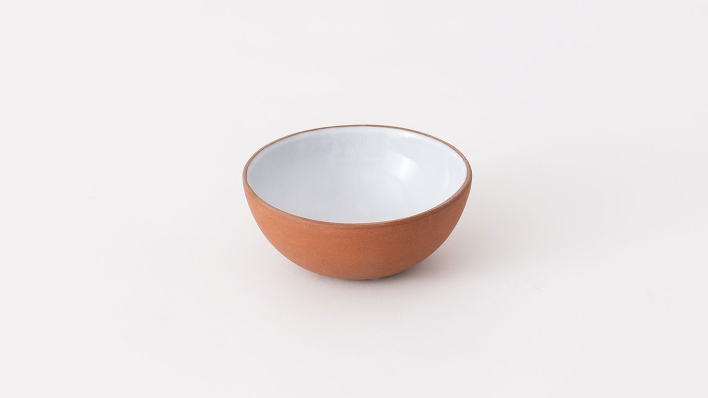 Top view of small red and white stoneware bowl