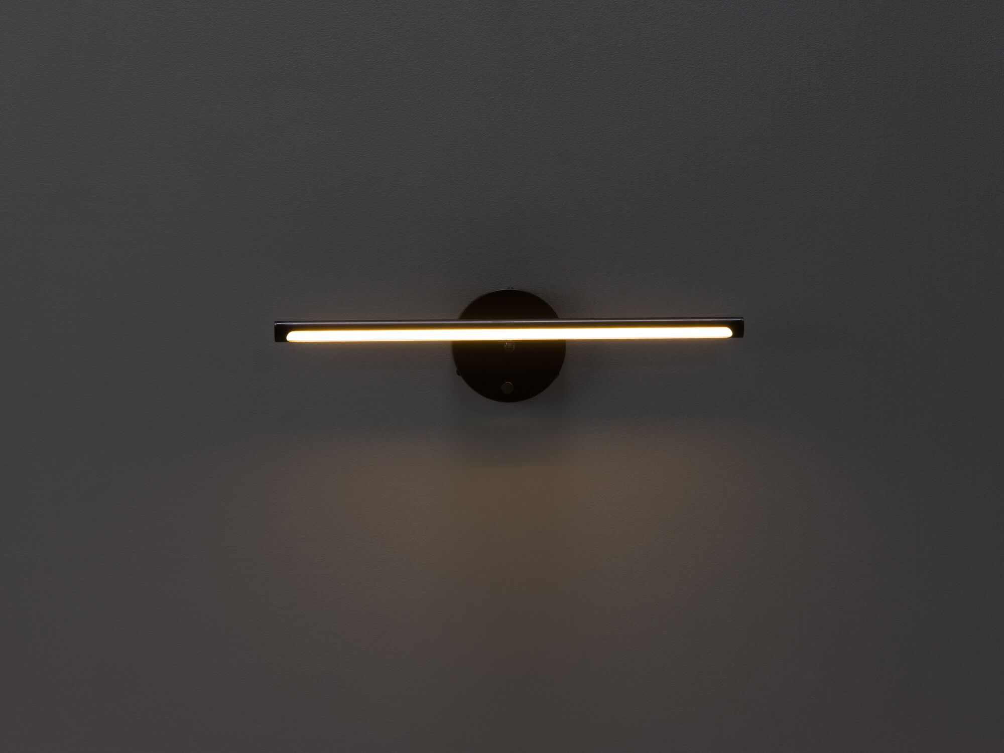 Black slim wall lamp with light on front view