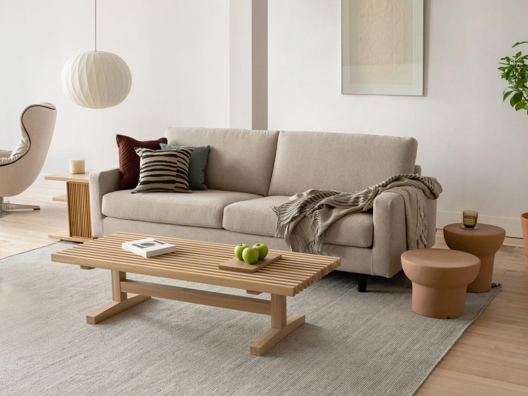 Terracotta stools on beige area rug in large modern living space