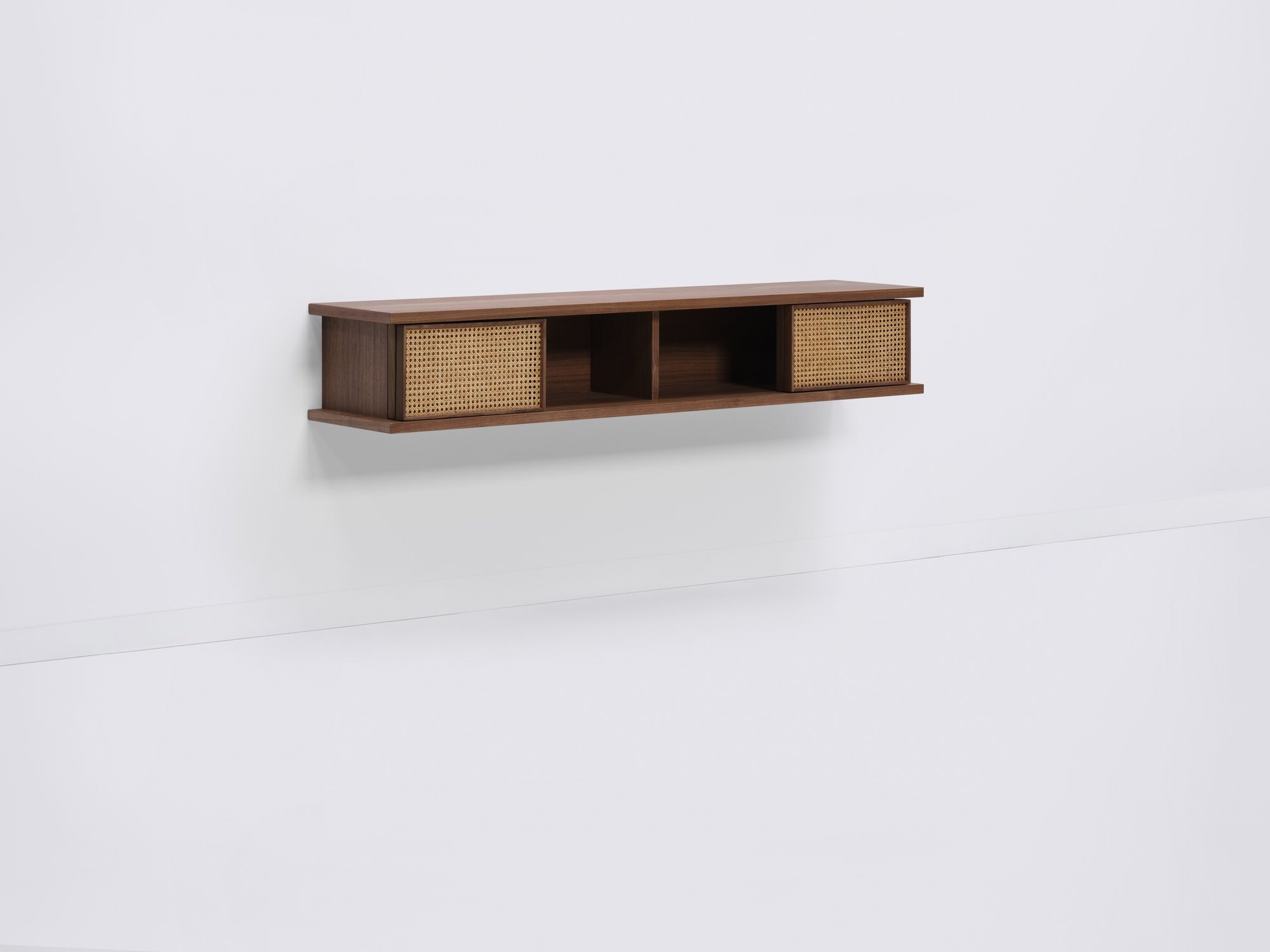 Medium walnut floating shelf with natural cane doors open front angle view