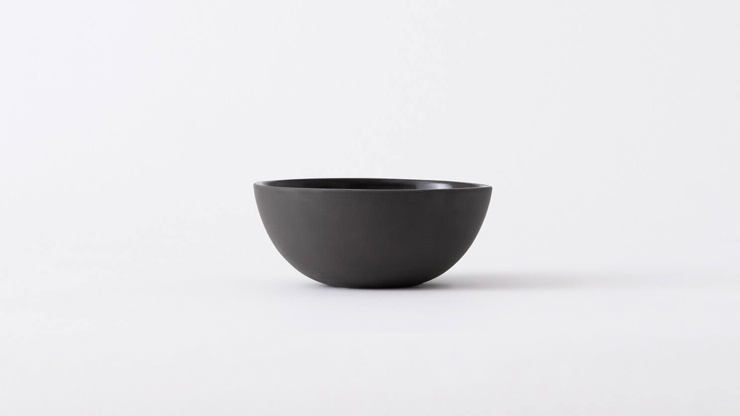 Small black stoneware bowl front view