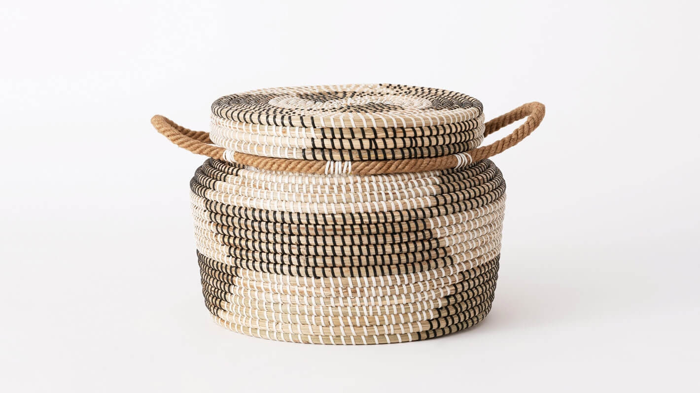 Side view of medium handwoven black and beige basket