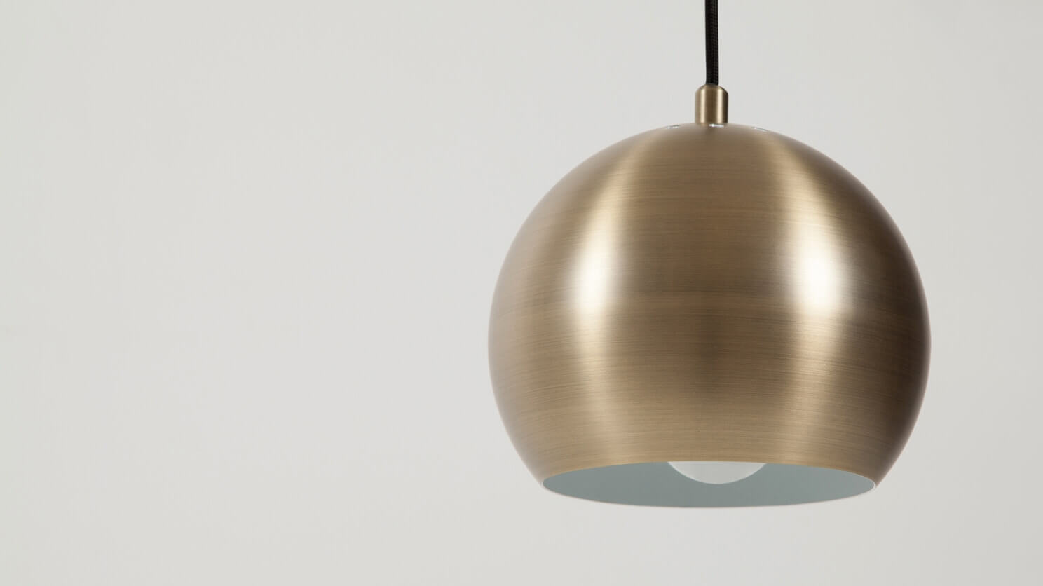 Detail view of the Ball contemporary pendant lamp in brushed brass