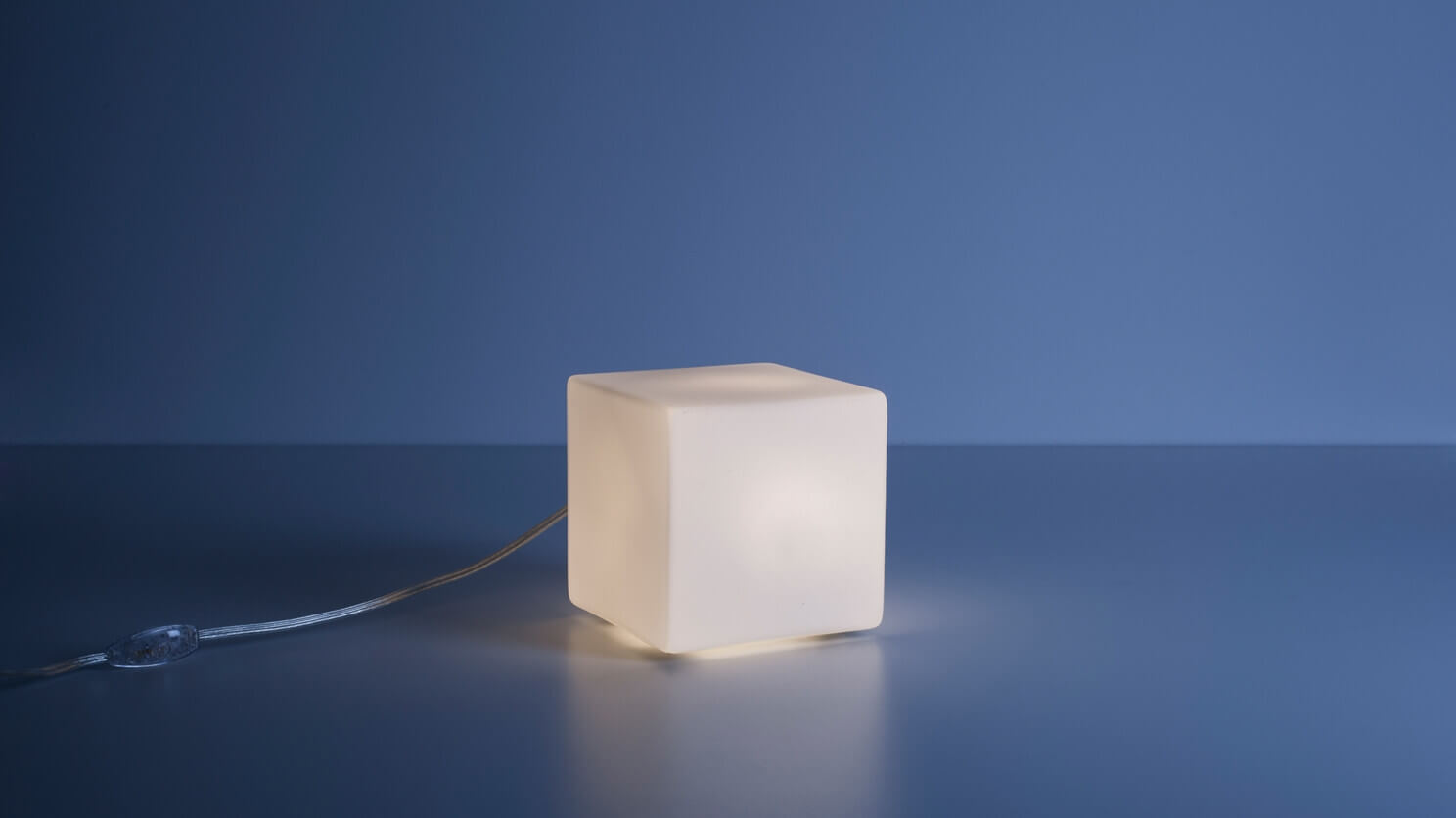 Front view of the large Boxy unique table lamp in a blue room