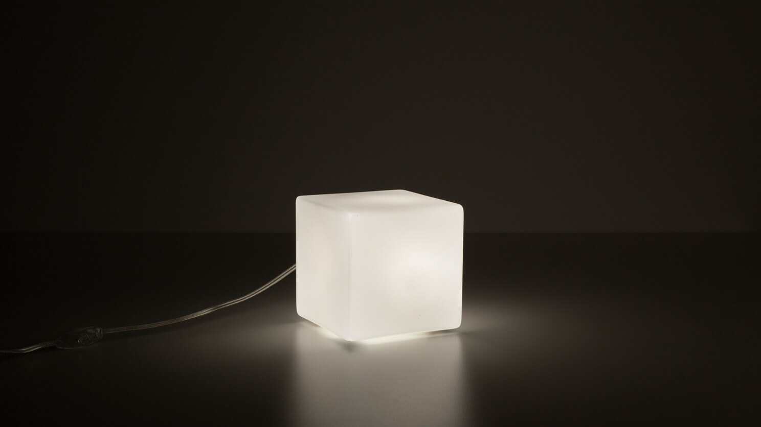 Front view of the large Boxy unique table lamp with light on