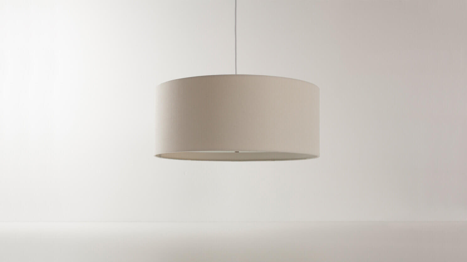 Front view of the Conick modern pendant lighting in a white room