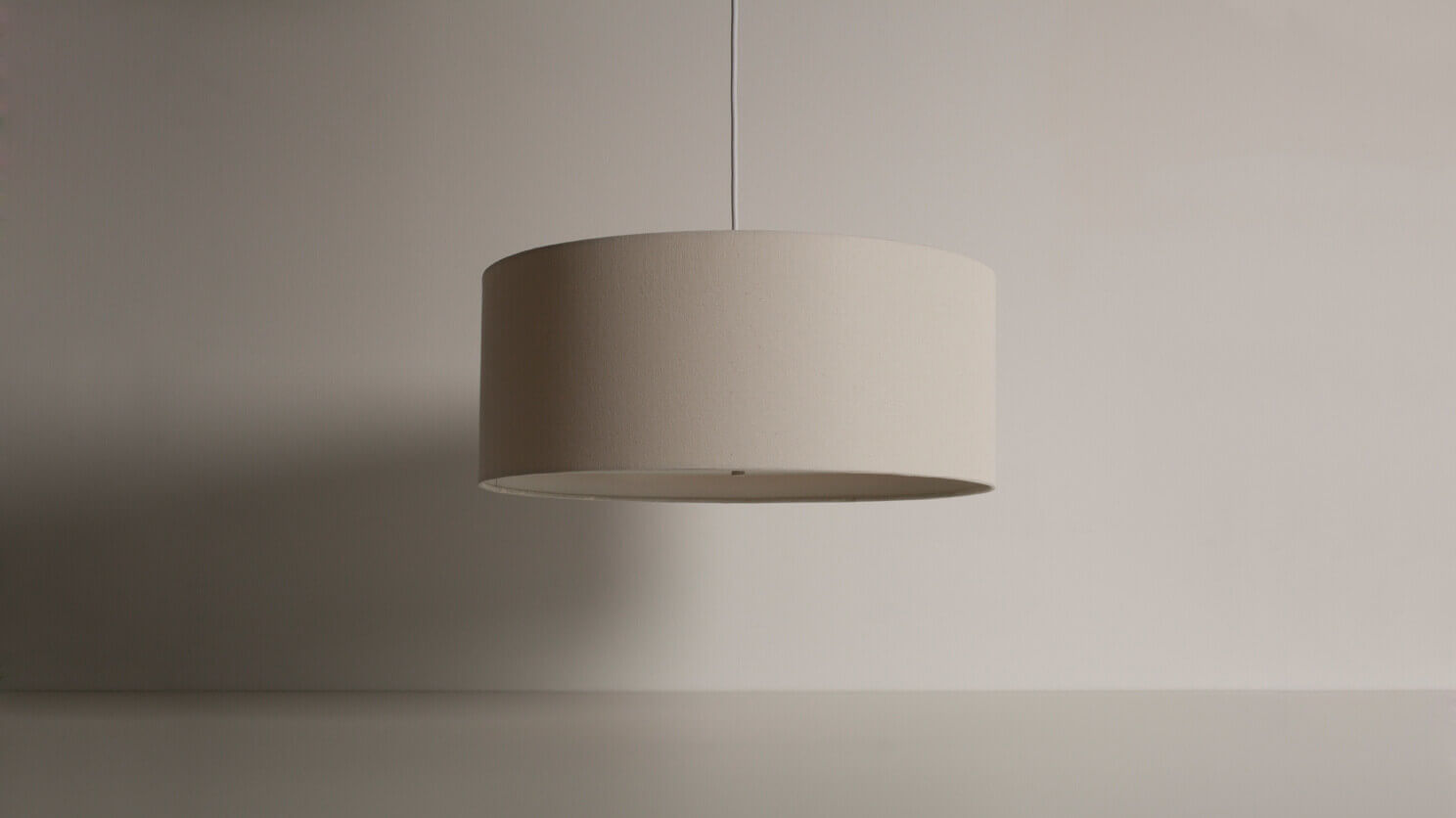 Front view of the Conick modern pendant lighting in a gray room