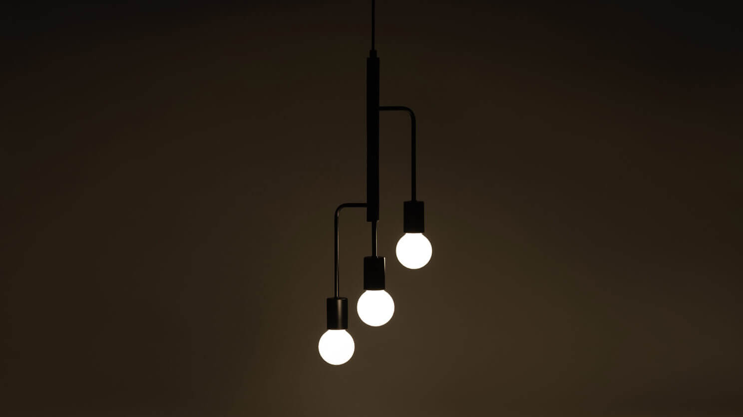 The Metro modern chandelier in black with light on