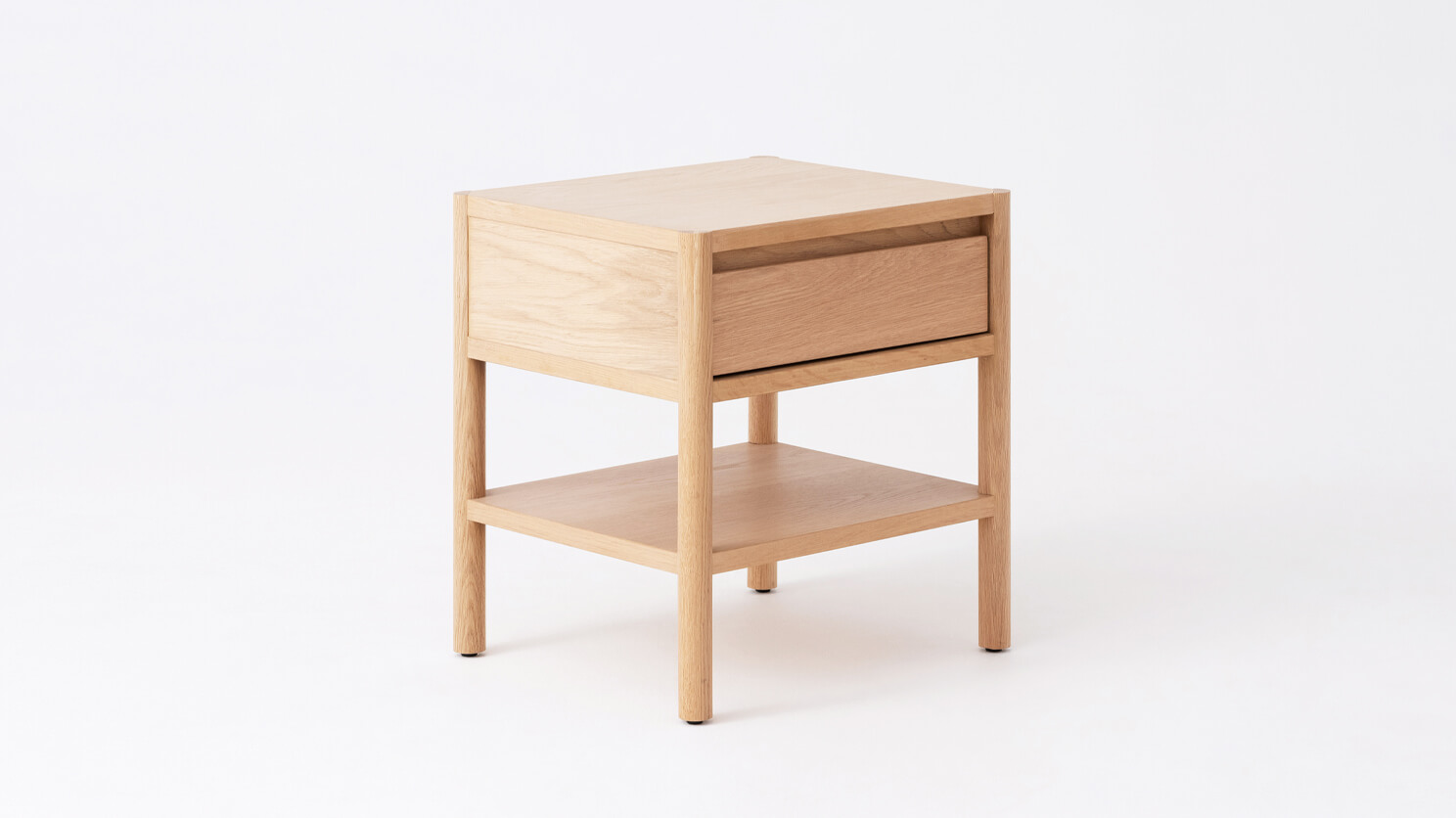 Angled view of the Monarch single drawer narrow nightstand in oak