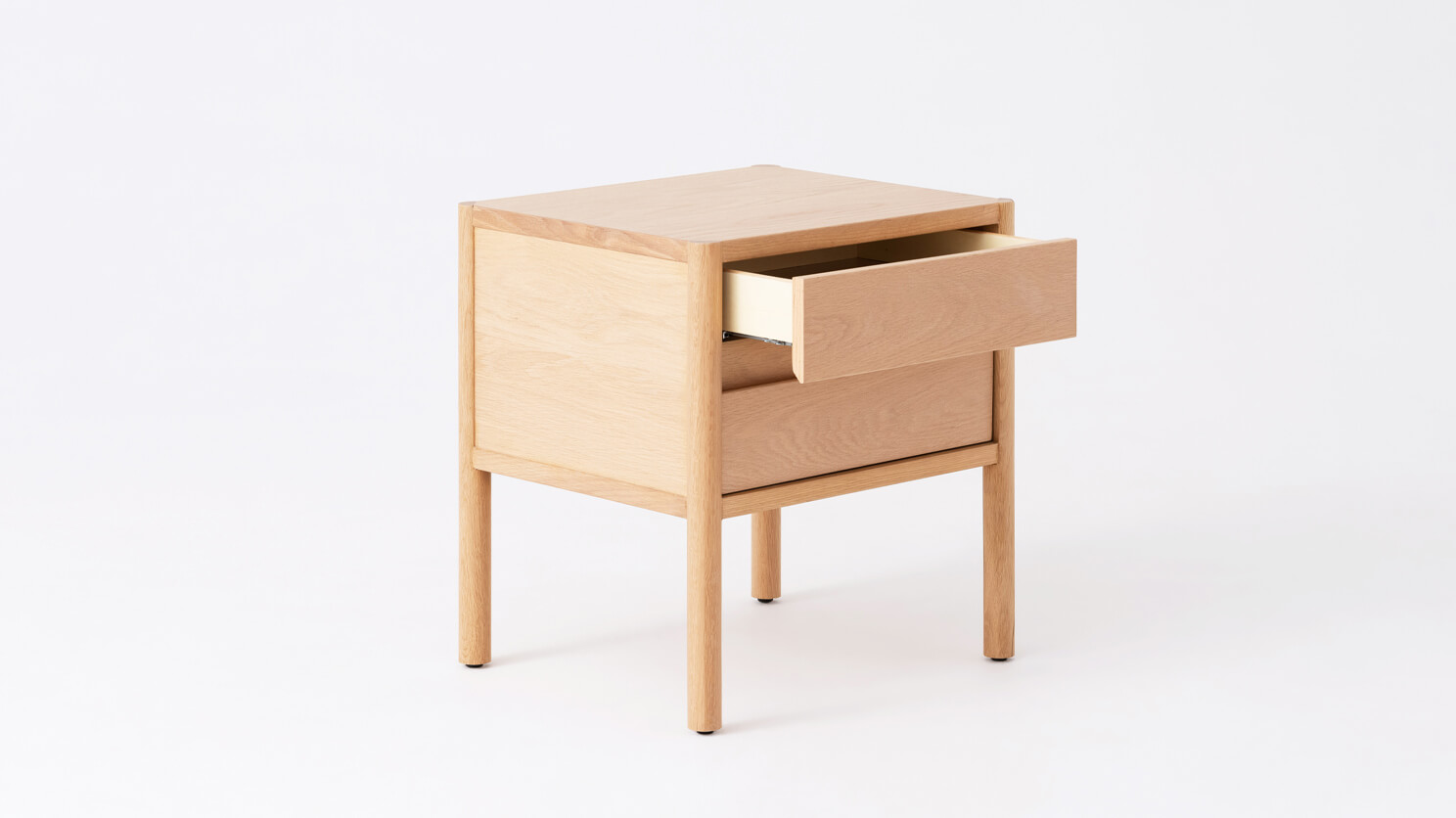 Angled view of the Monarch double drawer low nightstand in oak with drawer open