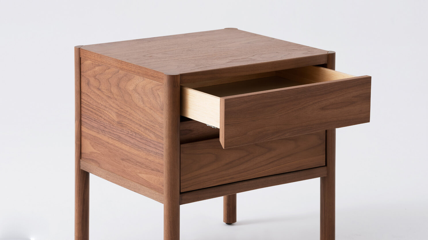 Double drawer nightstand in walnut with drawer open front angle view