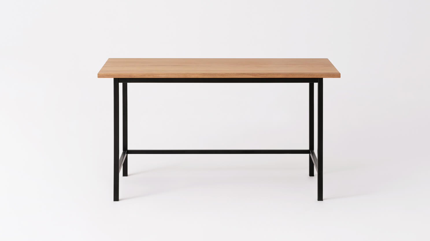 Front view of the Kendall studio desk with solid oak top and black base