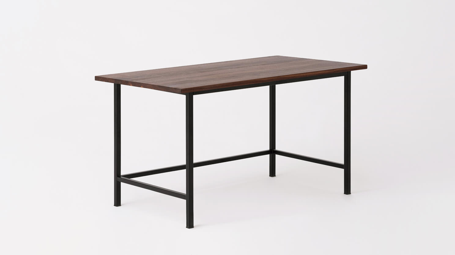 Angled view of the Kendall studio desk with solid walnut top and black base