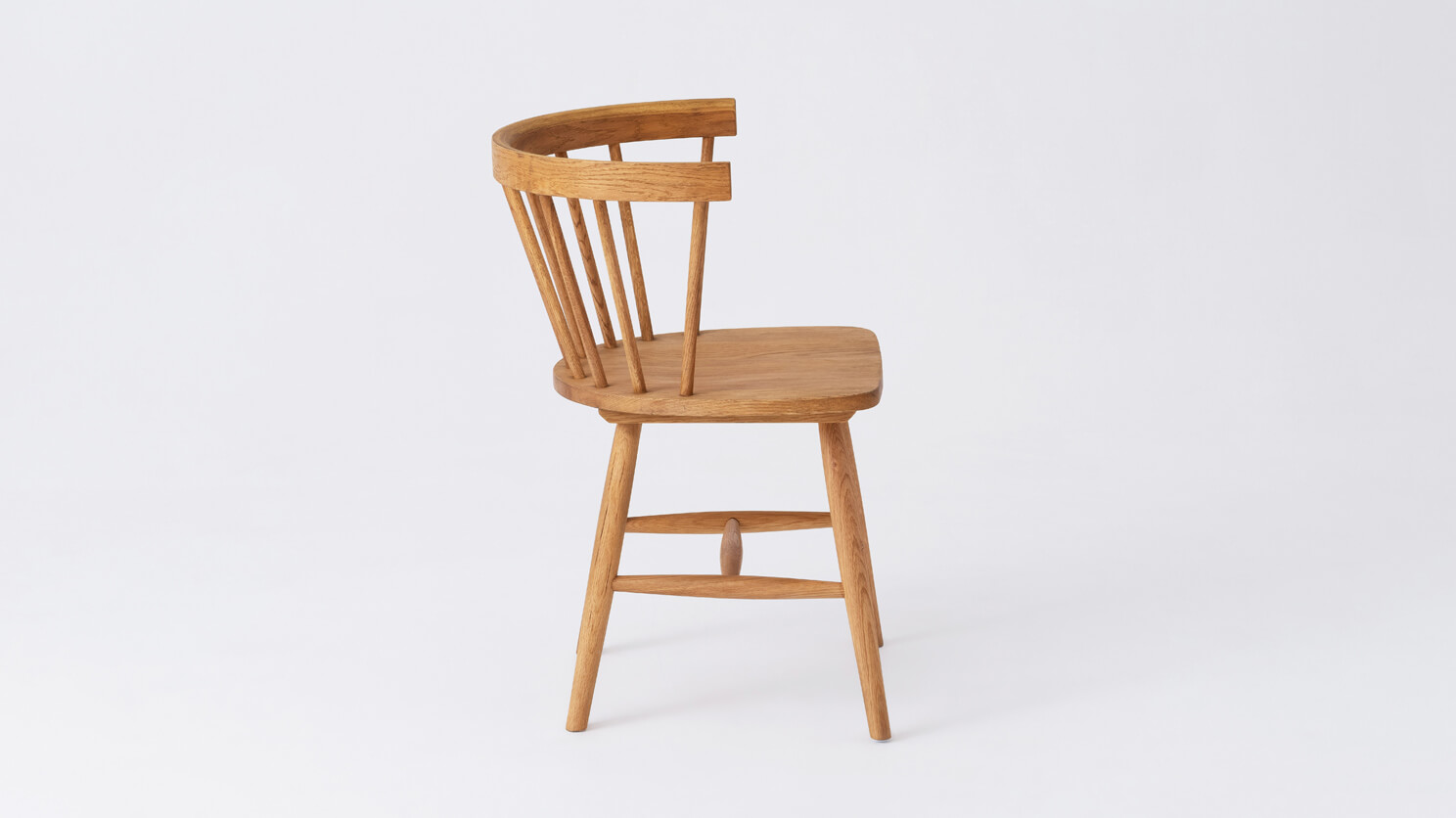 Side view of the Lyla mid century dining chair in solid oak