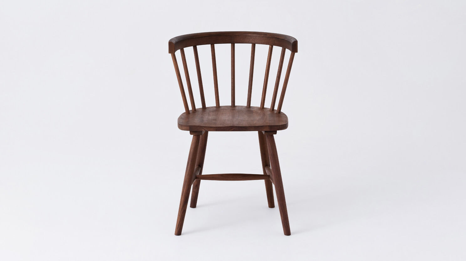 Front view of the Lyla mid century dining chair in solid walnut