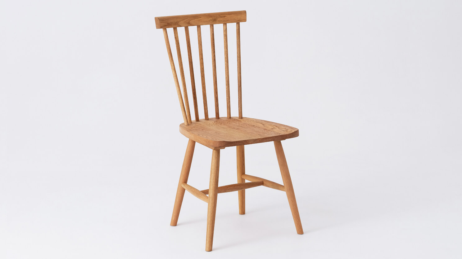 Angled view of the Lyla modern side dining room chair in solid oak