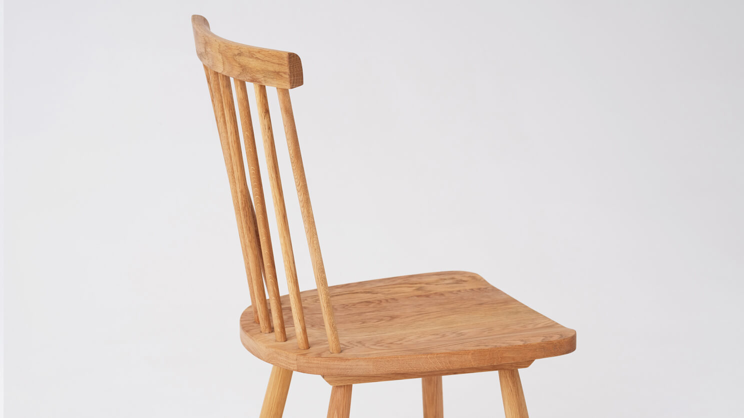 Detail view of the Lyla modern side dining room chair in solid oak