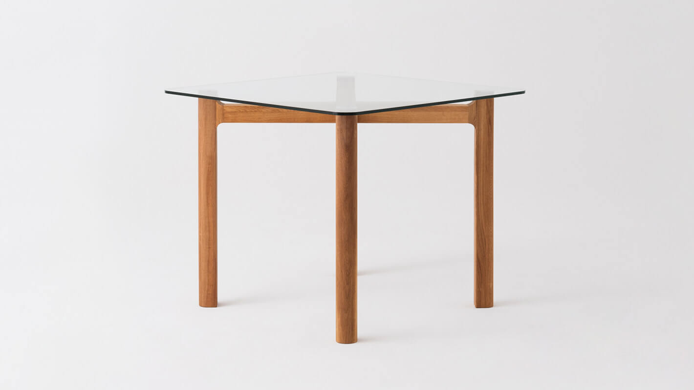 Side view of the Place square contemporary dinette table with clear glass top and oak legs