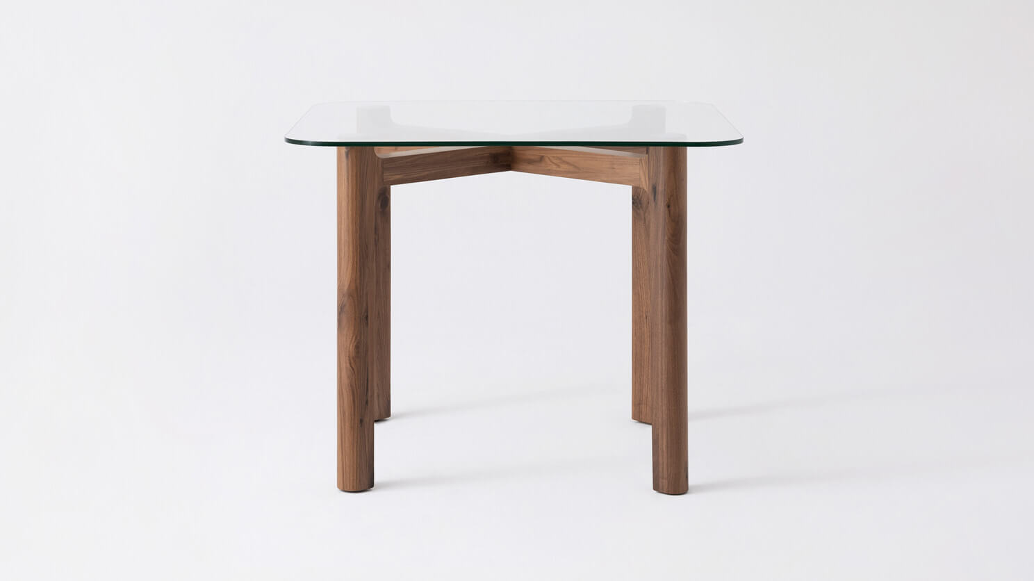 Front view of the Place square contemporary dinette table with clear glass top and walnut legs