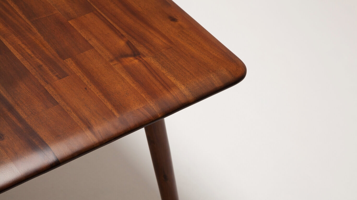 Detail view of the Kacia solid wood dining table in java