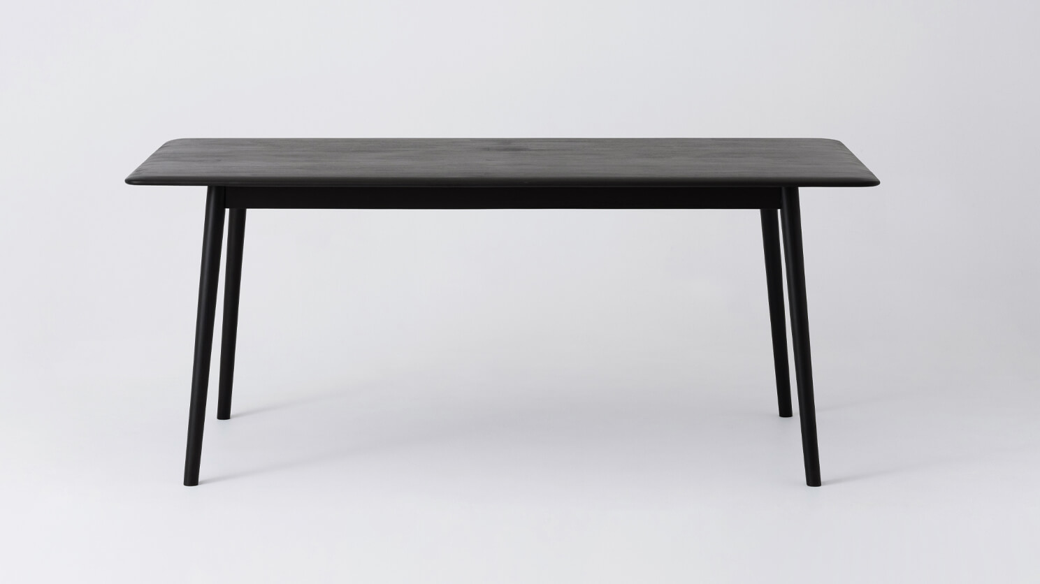 Front view of the medium sized Kacia solid wood dining table in black