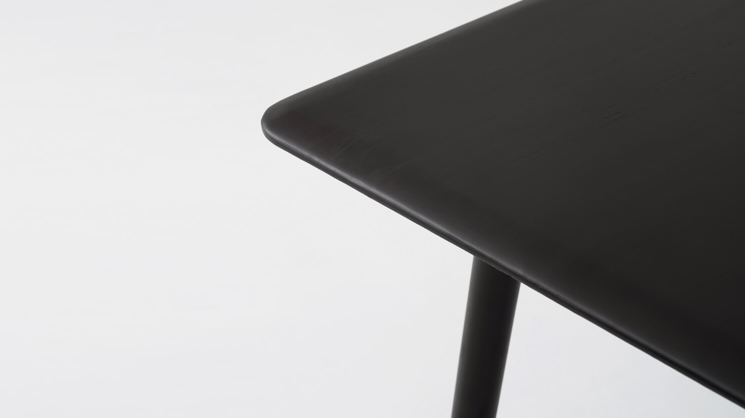 Detail view of the Kacia solid wood dining table in black