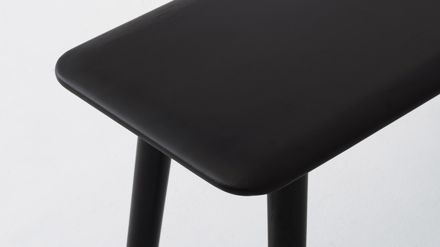 Detail view of Kacia dining bench in black