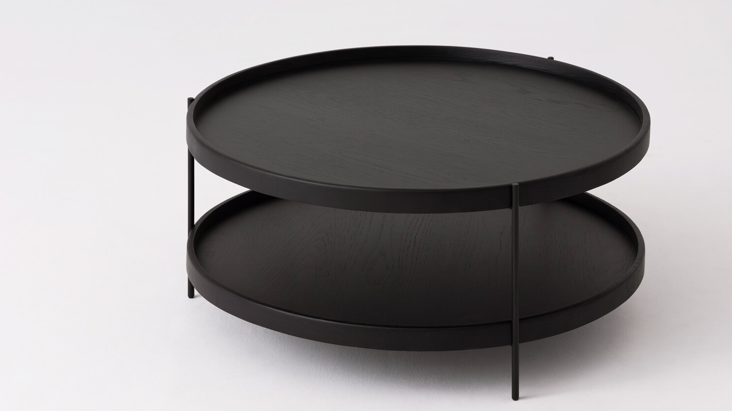 Detail view of the large Sage modern round coffee table in black oak