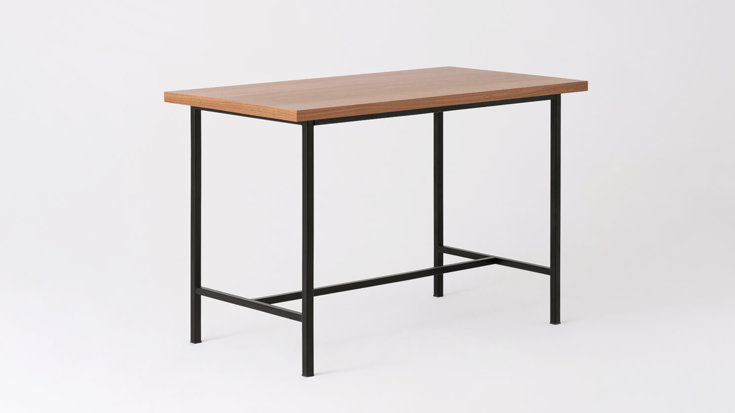 Angled view of the Kendall modern counter table with walnut veneer top and black base