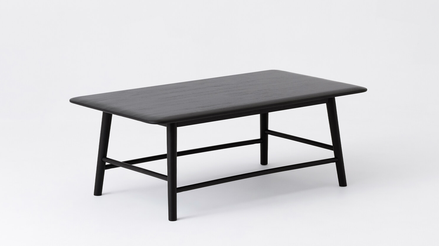 Angled view of the Kacia solid acacia wood coffee table in black