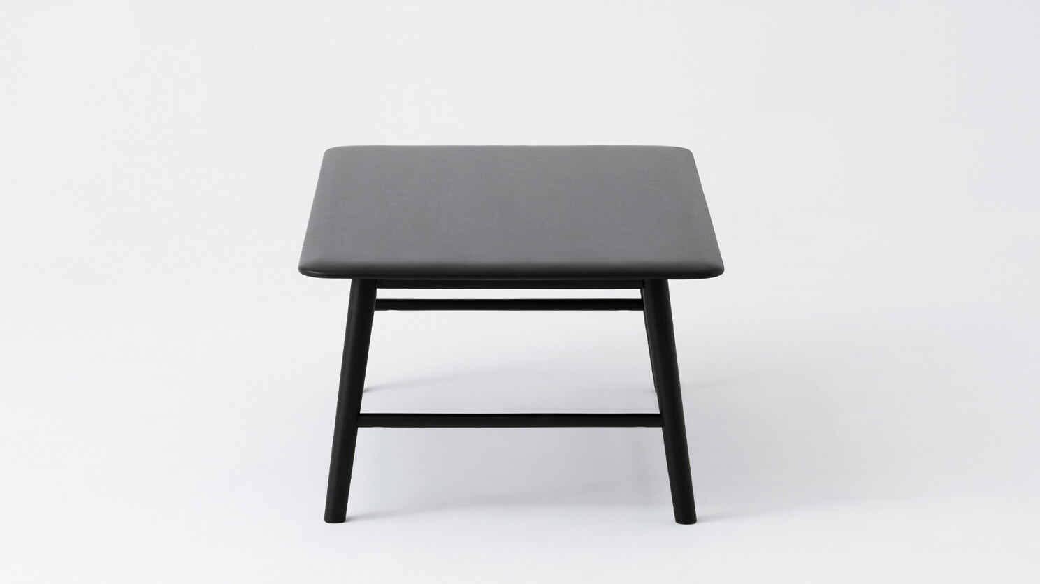 Side view of the Kacia solid acacia wood coffee table in black