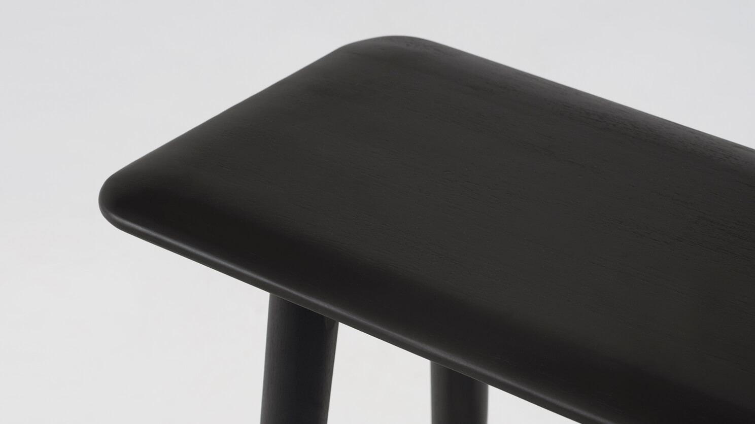 Detail view of the Kacia solid wood modern console in black