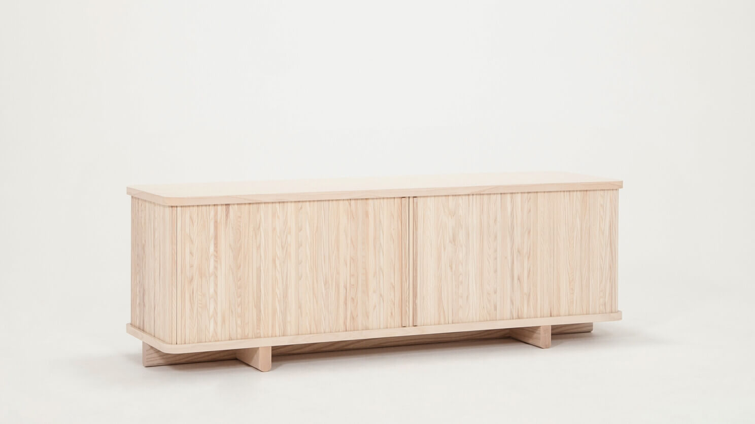 Angled view of the Tambour modern media console in ash