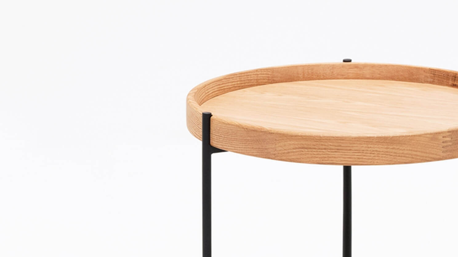 Detail view of the Sage modern round end table in oak