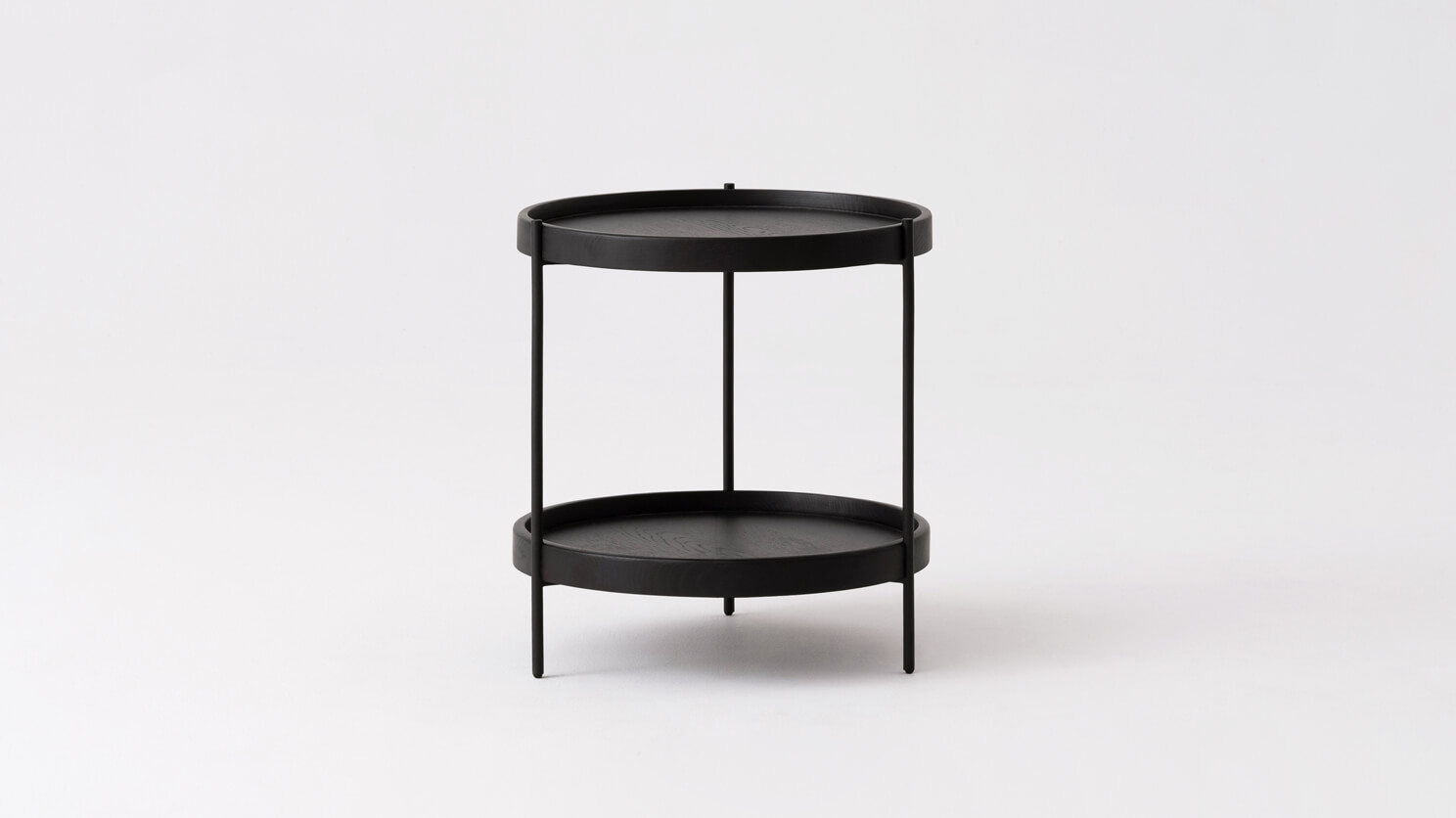 Front view of the Sage modern round end table in black oak