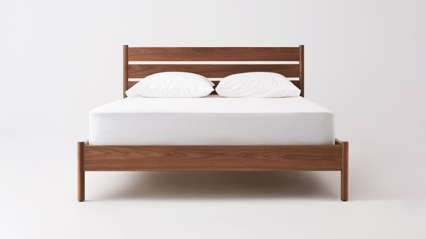 Front view of our modern platform bed Monarch in walnut