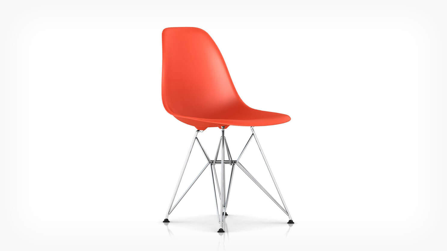 Front angle view of orange Eames molded plastic chair with wire base